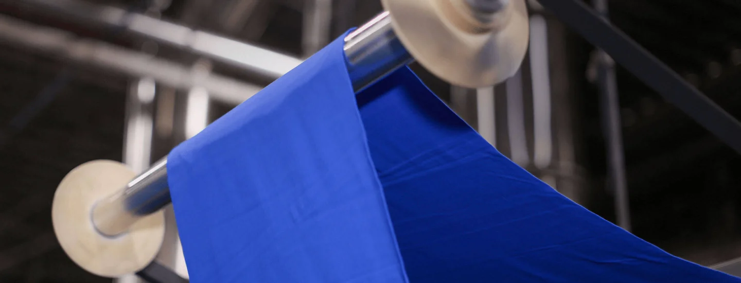 A close up image of Gildan blue fabric in the texitle facility.