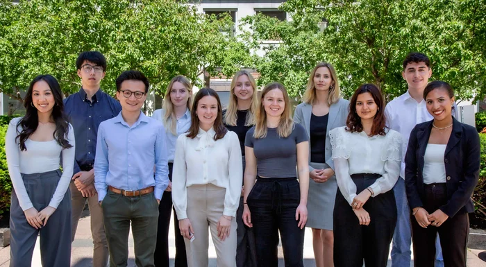 Gildan’s Corporate Head Office interns in Montreal are smiling at the camera while standing outside.