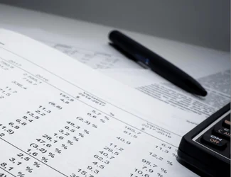 Three men and two women wearing Gildan™ on a beach looking at the camera.